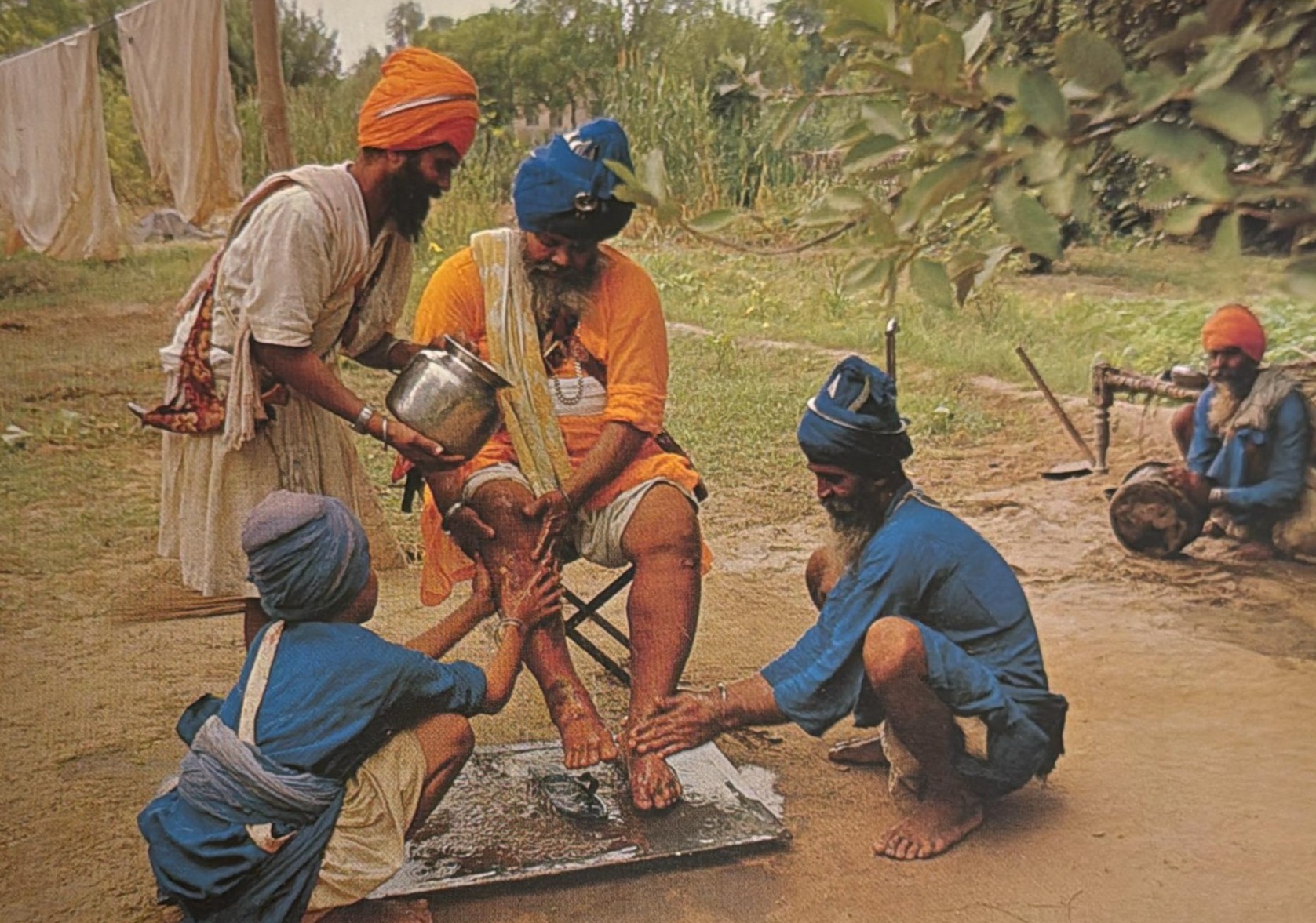 Santa Singh having his feet washed by followers