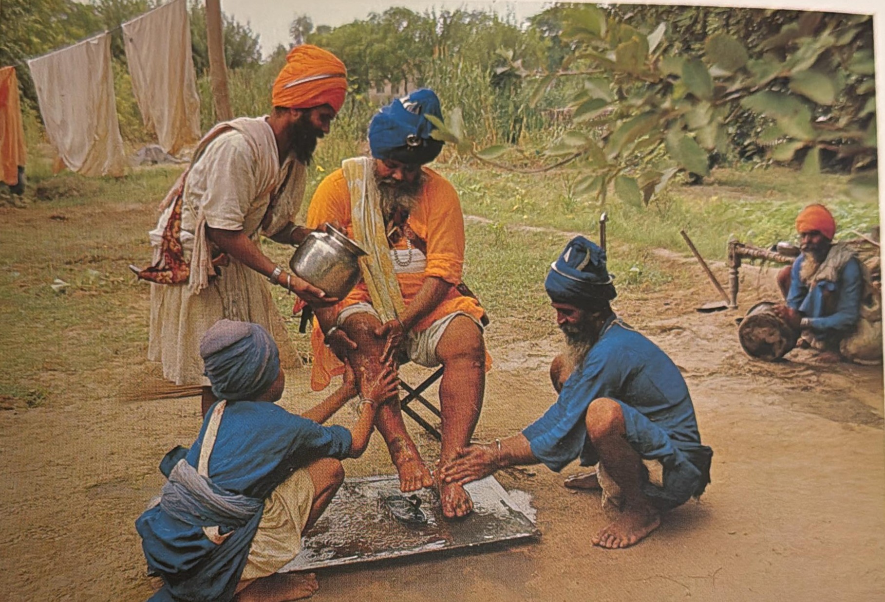 Santa Singh having his feet washed by followers