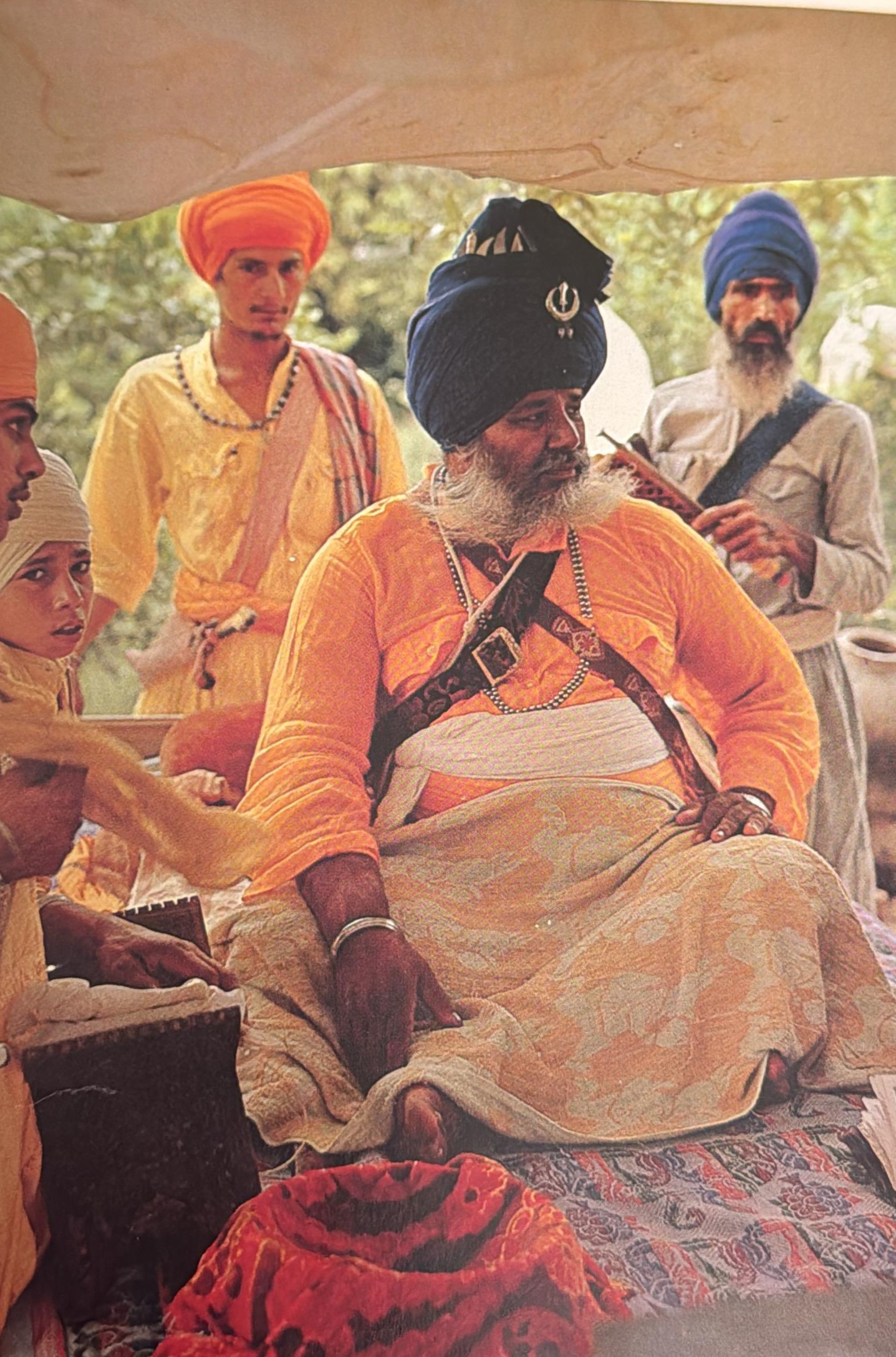 Santa Singh seated among followers