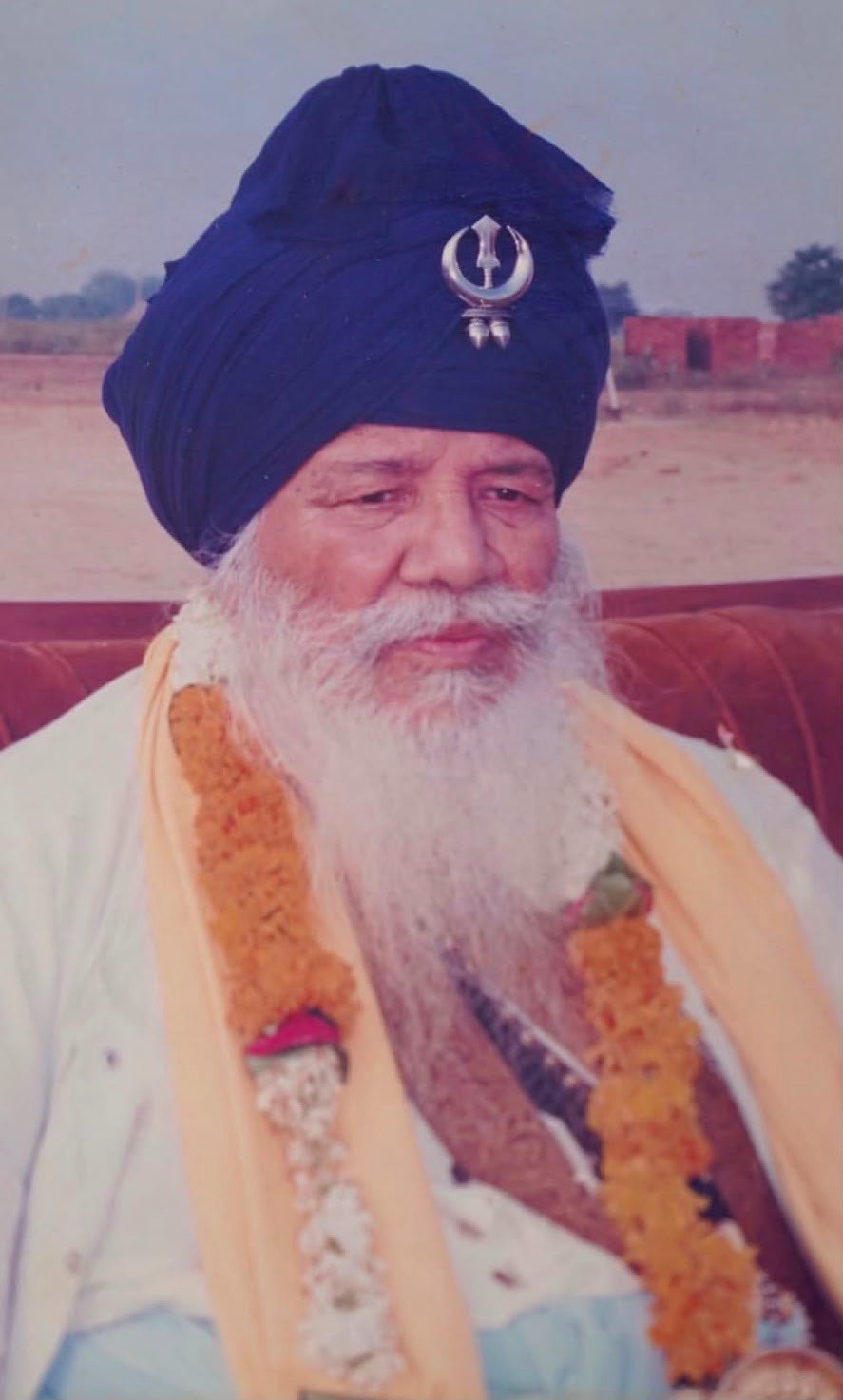 Santa Singh in later life, garlanded at a ceremonial occasion